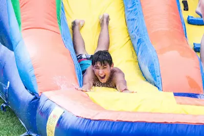 kid on inflatable slide