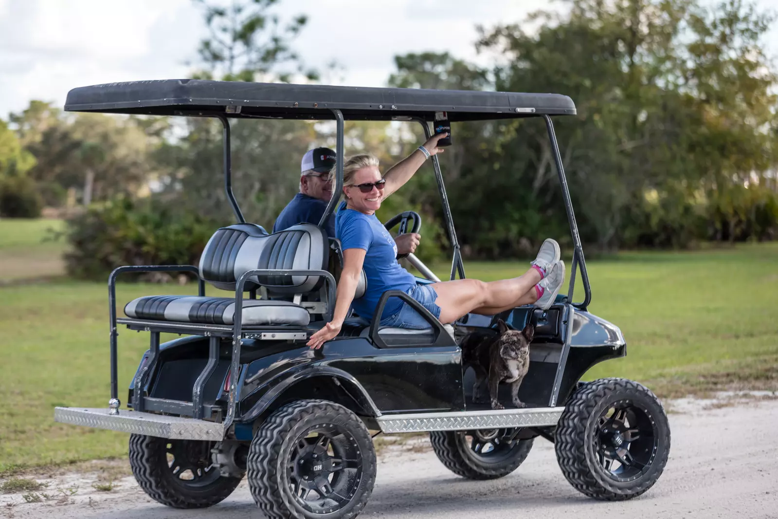 people in golf cart at resort